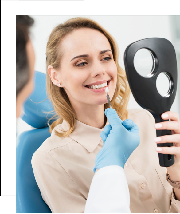 Stock image of a patient being shown teeth color to fix