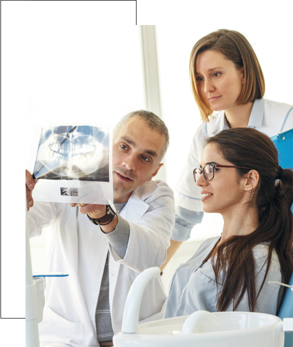 Stock image of doctor showing dental xray to paitent and explaining